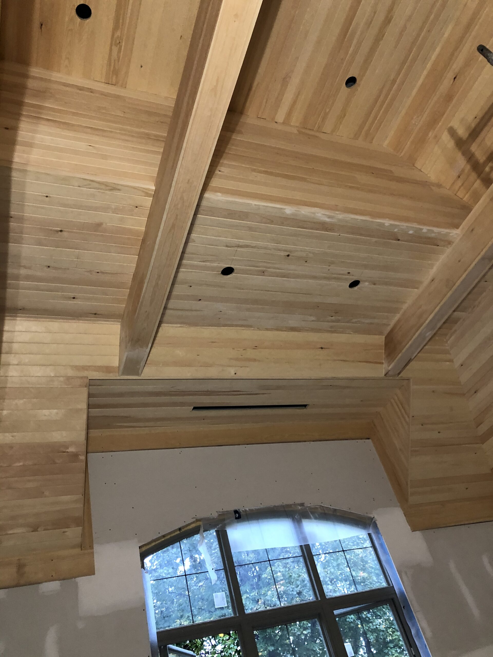 Vaulted wood ceiling with exposed beam