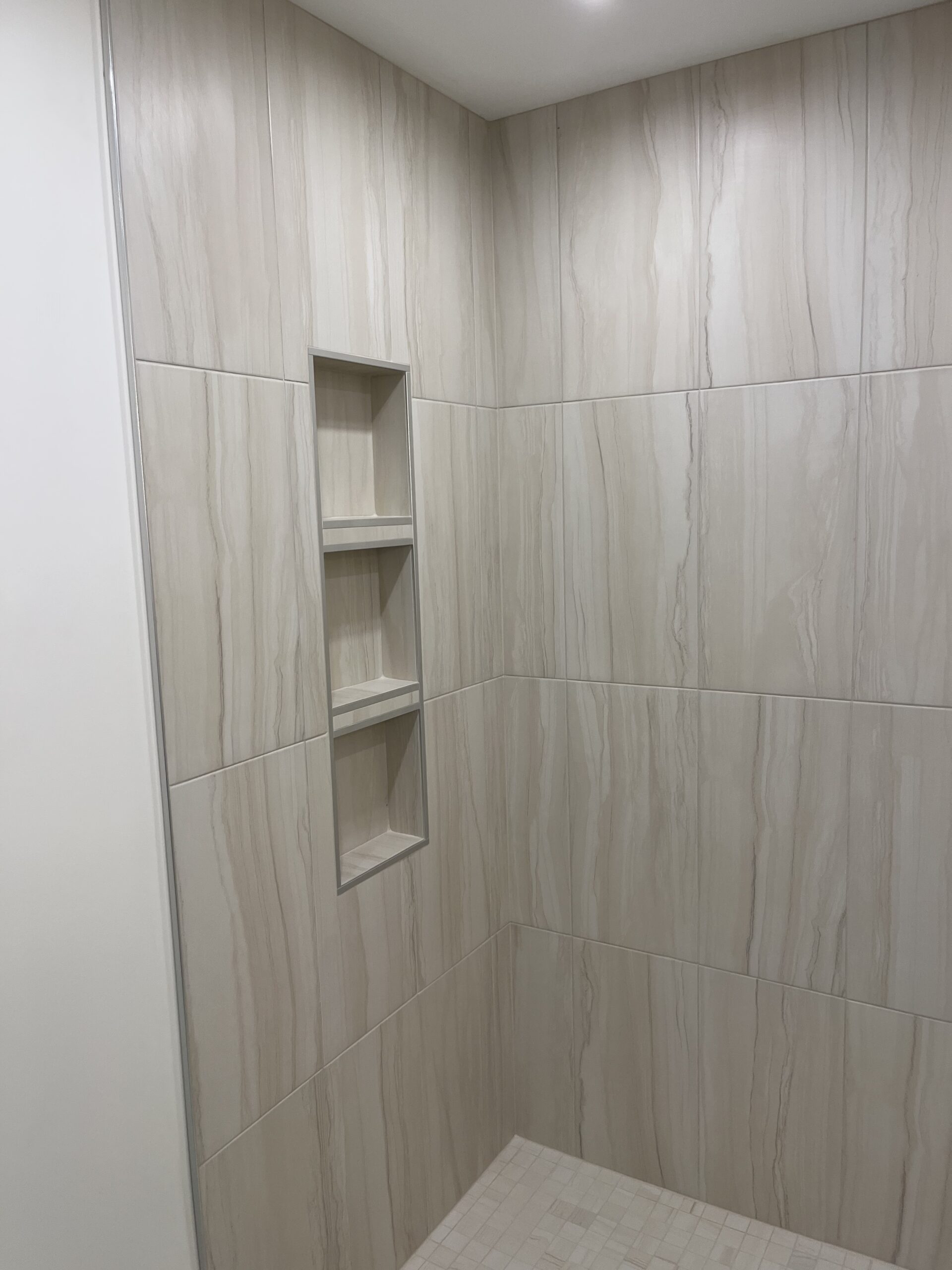 Bathroom shower tile with built-in niche shelving
