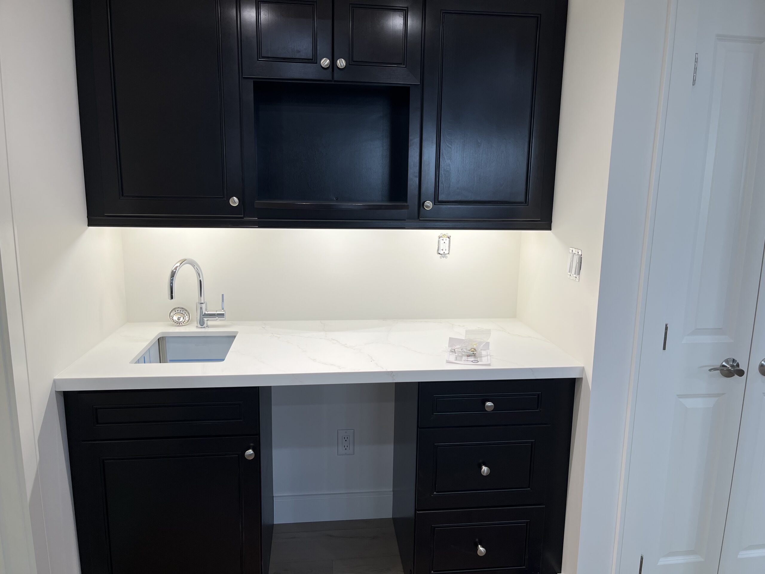 Small wet bar cabinetry with new quartz counter and faucet