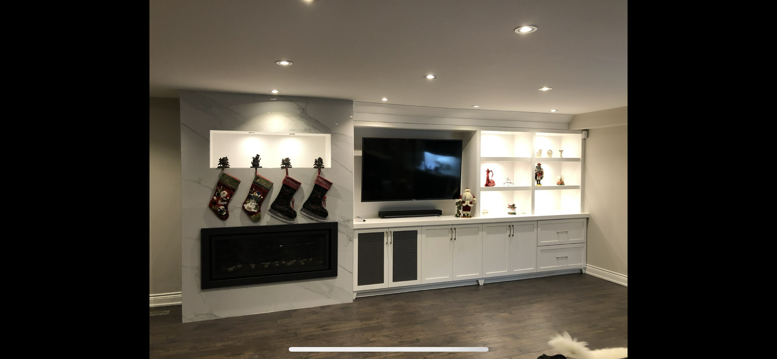 Custom marble fireplace wall with built-in media cabinetry