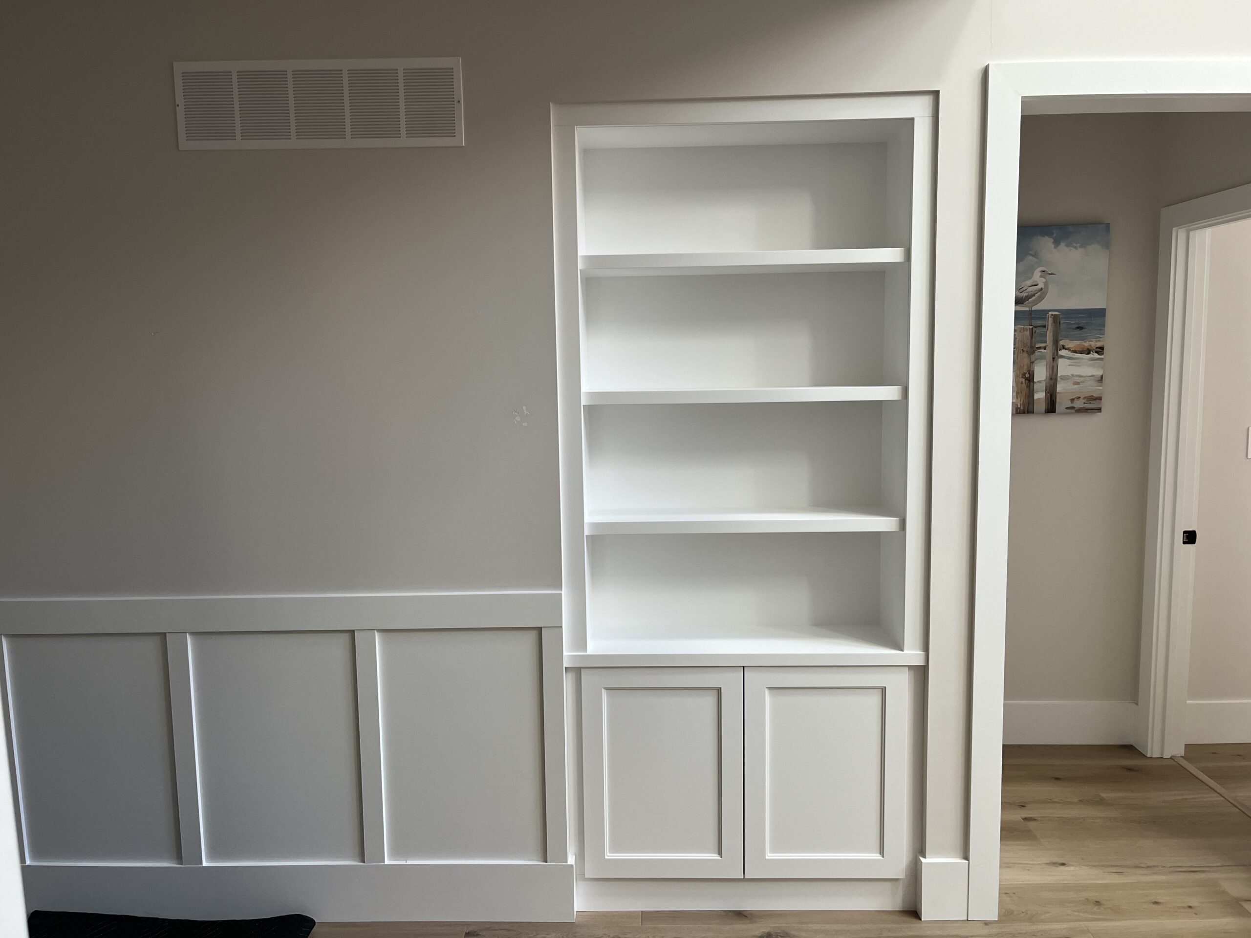 Built-in bookshelf with wainscoting trim